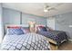 Inviting bedroom with two beds, coastal-themed decor, ceiling fan, and wood-look floors at 8560 Queensway Blvd. # 1206, Myrtle Beach, SC 29572