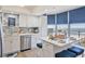 Bright kitchen features an island with seating and ocean views through large windows with blue shades at 8560 Queensway Blvd. # 1206, Myrtle Beach, SC 29572