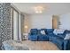 Well-decorated living room featuring a comfortable blue sectional sofa and coastal-themed decor at 8560 Queensway Blvd. # 1206, Myrtle Beach, SC 29572