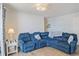 Comfortable living room featuring a plush blue sectional sofa and coastal-themed decor at 8560 Queensway Blvd. # 1206, Myrtle Beach, SC 29572