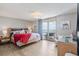 Bedroom with bed, lamps, and balcony overlooking beach with water views at 8560 Queensway Blvd. # 1206, Myrtle Beach, SC 29572