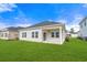 Well-maintained backyard with green grass and a covered patio at 8704 High Banks Way, Longs, SC 29568
