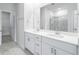 Modern bathroom with double sinks, tiled flooring, and a glass shower enclosure at 8704 High Banks Way, Longs, SC 29568