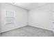 Empty bedroom with a window, carpet, and neutral walls, ready for customization at 8704 High Banks Way, Longs, SC 29568