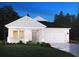 Charming single-story home featuring a two-car garage and a beautifully landscaped front yard at 8704 High Banks Way, Longs, SC 29568