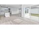 Bright, open living space with wood floors, a sliding glass door to the backyard and a modern kitchen at 8704 High Banks Way, Longs, SC 29568