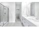 Stylish bathroom with double sink vanity, tiled floors, and a glass-enclosed shower at 8720 High Banks Way, Longs, SC 29568