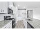 Stylish kitchen features white cabinetry, granite countertops, stainless appliances, and subway tile backsplash at 8720 High Banks Way, Longs, SC 29568