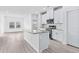 Modern kitchen with granite counters, stainless appliances and luxury vinyl plank flooring at 8720 High Banks Way, Longs, SC 29568