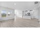 Bright and open floor plan with wood-look floors connects the living and kitchen areas at 8720 High Banks Way, Longs, SC 29568