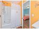 Cozy bathroom featuring a shower with curtain and a glimpse into an adjacent bedroom with twin beds at 939 Tiffany Ln., North Myrtle Beach, SC 29582