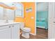 Bright bathroom with white vanity and a peek into the bedroom at 939 Tiffany Ln., North Myrtle Beach, SC 29582