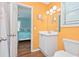 Cheerful bathroom with a well-lit vanity and a glimpse into an adjacent bedroom at 939 Tiffany Ln., North Myrtle Beach, SC 29582