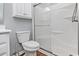 Bathroom featuring a walk-in shower with sliding glass doors, ample cabinet space and wood-look flooring at 939 Tiffany Ln., North Myrtle Beach, SC 29582
