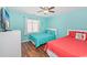 Bright bedroom featuring two twin beds with color-coordinated decor and a ceiling fan at 939 Tiffany Ln., North Myrtle Beach, SC 29582