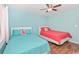 Bright bedroom featuring two twin beds with color-coordinated decor and a ceiling fan at 939 Tiffany Ln., North Myrtle Beach, SC 29582