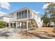 Charming raised beach house with a screened porch, sturdy stilts, and lush, low-maintenance landscaping at 939 Tiffany Ln., North Myrtle Beach, SC 29582
