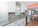 The kitchen features granite countertops, tile backsplash, and stainless steel appliances at 939 Tiffany Ln., North Myrtle Beach, SC 29582