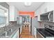 Galley kitchen featuring granite countertops, stainless steel appliances, and tiled backsplash at 939 Tiffany Ln., North Myrtle Beach, SC 29582