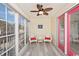Inviting screened porch featuring cozy seating, bright pops of color, and views of the surrounding scenery at 939 Tiffany Ln., North Myrtle Beach, SC 29582