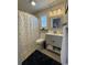 Bright bathroom with a polka dot shower curtain, stylish vanity and modern fixtures at 971 Blue Stem Dr. # 41 H, Pawleys Island, SC 29585