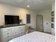 Bright bedroom featuring a white dresser, a large-screen TV, a full-length mirror, and nautical themed decor at 971 Blue Stem Dr. # 41 H, Pawleys Island, SC 29585