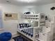 Coastal-themed bunk room with white bunk beds featuring a ladder with drawers for additional storage at 971 Blue Stem Dr. # 41 H, Pawleys Island, SC 29585