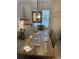 Inviting dining area with rustic wood table, stylish light fixture, and coastal decor at 971 Blue Stem Dr. # 41 H, Pawleys Island, SC 29585