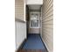 A welcoming front entrance featuring a blue floor mat and sidelight windows at 971 Blue Stem Dr. # 41 H, Pawleys Island, SC 29585