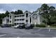 Attractive condo building with stacked balconies, well-maintained landscaping, and ample parking at 971 Blue Stem Dr. # 41 H, Pawleys Island, SC 29585