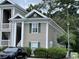 Close-up of condo building exterior showcasing windows with shutters and mature landscaping at 971 Blue Stem Dr. # 41 H, Pawleys Island, SC 29585