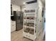 Neat kitchen storage with a ladder-style shelving unit, and a stainless steel refrigerator at 971 Blue Stem Dr. # 41 H, Pawleys Island, SC 29585