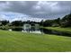 Scenic view of a pond with a fountain, surrounded by lush greenery and buildings in the background at 971 Blue Stem Dr. # 41 H, Pawleys Island, SC 29585