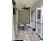 A well-lit porch featuring neutral siding, a brick floor, two chairs, and a ceiling fan at 971 Blue Stem Dr. # 41 H, Pawleys Island, SC 29585