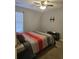 Clean bedroom features ceiling fan, carpet, and blank TV mount on wall at 9903 Conifer Ln., Murrells Inlet, SC 29576