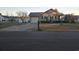 Welcoming single-story home featuring an attached garage and a well-kept lawn at 9903 Conifer Ln., Murrells Inlet, SC 29576