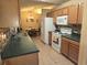 Features of kitchen include tile floors, sink, stove, and microwave at 9903 Conifer Ln., Murrells Inlet, SC 29576