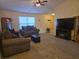 Inviting living room with plush seating, fireplace, and entertainment center at 9903 Conifer Ln., Murrells Inlet, SC 29576
