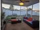 Inviting screened porch featuring comfortable seating and a view of the fenced backyard at 9903 Conifer Ln., Murrells Inlet, SC 29576