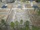 Aerial view of house on large lot with fenced backyard and mature trees at 10015 W Highway 19, Loris, SC 29569