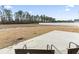 Spacious backyard featuring a large concrete patio perfect for outdoor seating and entertaining at 10015 W Highway 19, Loris, SC 29569