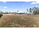 Expansive backyard with a white fence, offering ample space and privacy with views of the home at 10015 W Highway 19, Loris, SC 29569