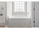 Bright bathroom features a shower and a large soaking tub with a window at 10015 W Highway 19, Loris, SC 29569