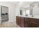 Bathroom features a dual sink vanity with wood cabinets and walk-in closet access at 10015 W Highway 19, Loris, SC 29569