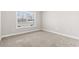 Bedroom with large window with plenty of natural light and neutral carpeting at 10015 W Highway 19, Loris, SC 29569