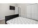 Bedroom featuring neutral walls, a wall-mounted TV, and a convenient closet for ample storage at 10015 W Highway 19, Loris, SC 29569