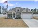 Inviting single-Gathering home boasting a two-car garage and manicured front yard at 10015 W Highway 19, Loris, SC 29569