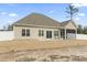 The back of the property with a screened-in porch and patio at 10015 W Highway 19, Loris, SC 29569