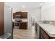Modern kitchen features stainless steel appliances, granite countertops, and wood-look floors at 10015 W Highway 19, Loris, SC 29569