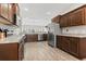 Open concept kitchen with stainless appliances, granite counters, and wood cabinets at 10015 W Highway 19, Loris, SC 29569